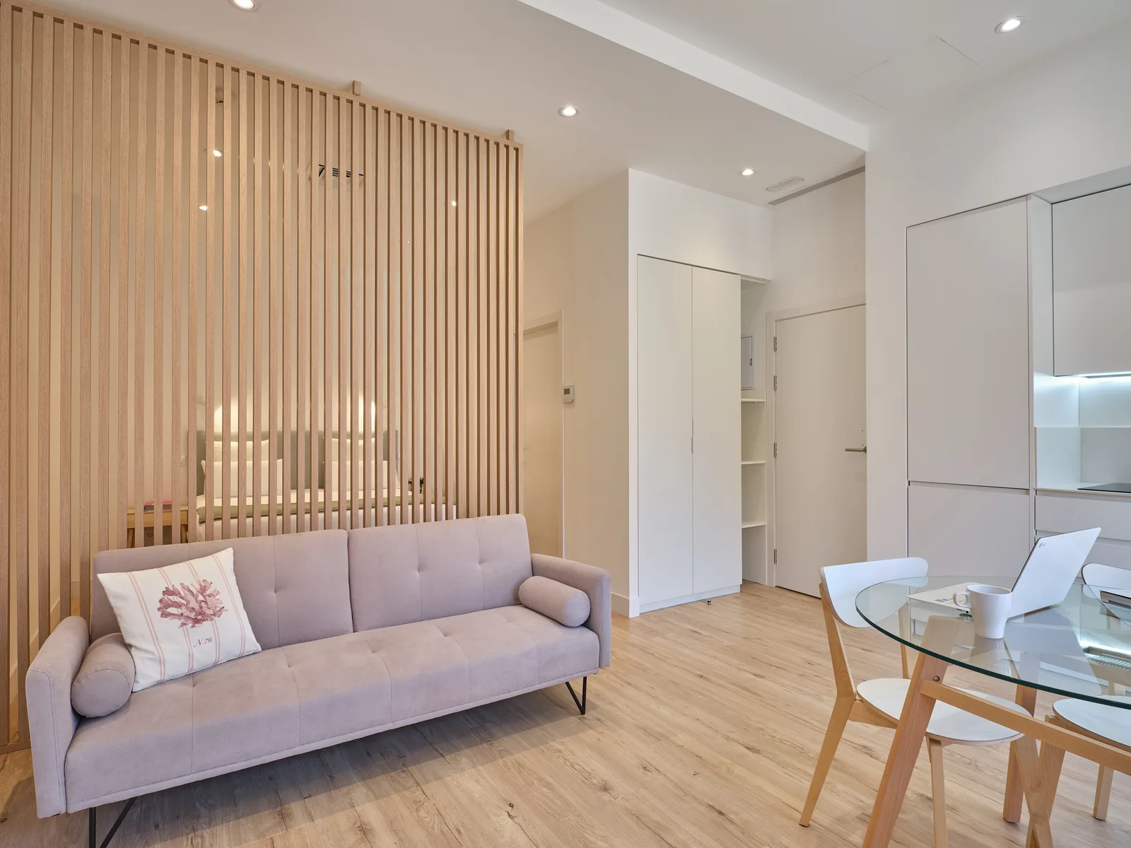 Matrimonial Suite — Living area with sofa and wooden divider, Paseo Suites Madrid